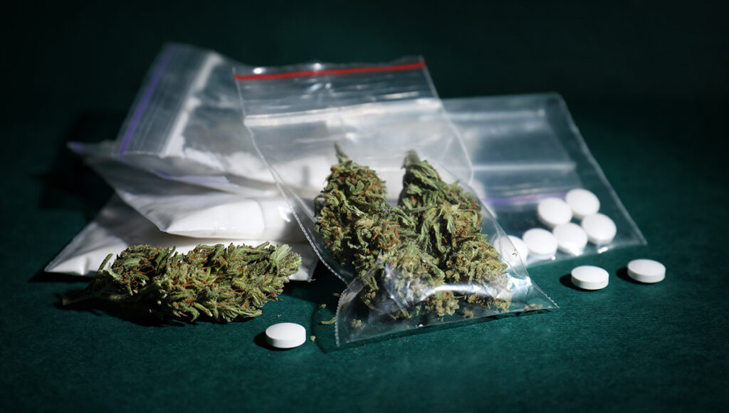 Cocaine, dried hemp and ecstasy on color background